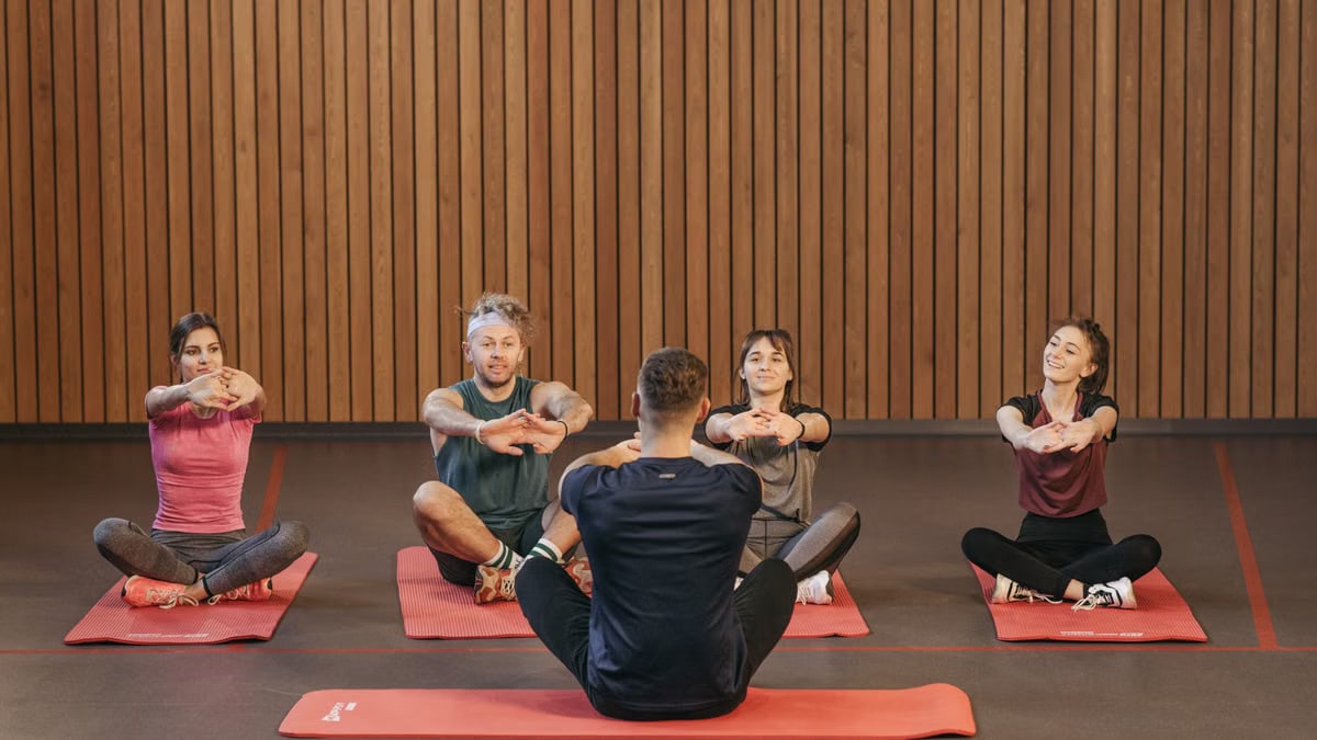 A diverse group practicing yoga in a studio with a focus on wellness and mindfulness.
